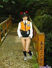 Asian slut in pigtails and uniform shows her hairy pussy and her favorite toys